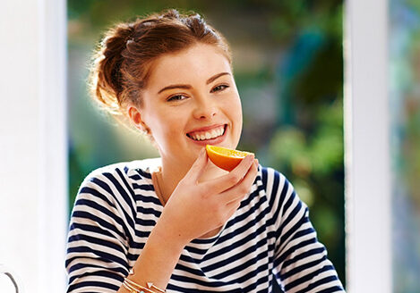Benefits of dance- happy woman eating fruit